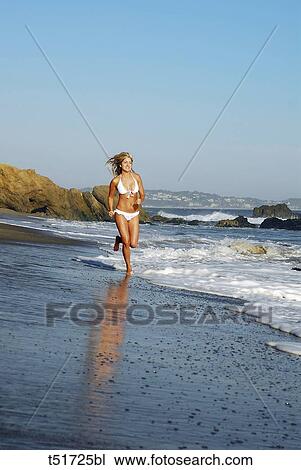 Woman runnig on the seashore View Large Photo Image Stock Image - Woman runnig on the seashore . Fotosearch