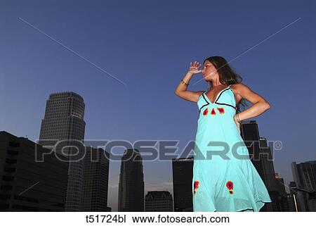 Woman standing on the roof of a skyscraper View Large Photo Image Stock Image - Woman standing on the roof of a skyscraper . Fotosearch