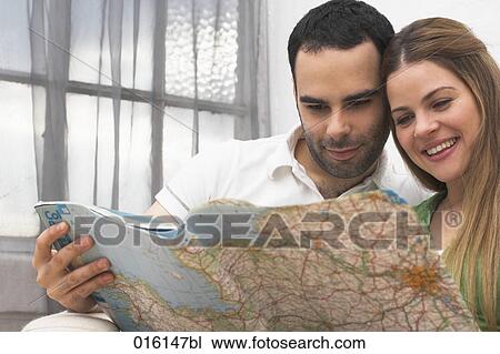 young couple looking at roadmap to plan their holiday View Large Photo Image Stock Image - young couple looking at roadmap to plan their holiday. Fotosearch