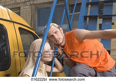 young couple outdoors sharing earphones to listen to music View Large Photo Image Stock Image - young couple outdoors sharing earphones to listen to music. Fotosearch