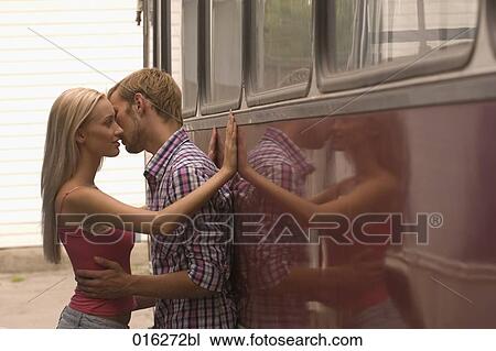 young couple standing at bus embracing and kissing View Large Photo Image Stock Image - young couple standing at bus embracing and kissing. Fotosearch