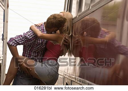 young couple standing at bus embracing and kissing View Large Photo Image Stock Image - young couple standing at bus embracing and kissing. Fotosearch