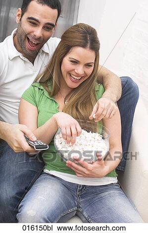 young couple watching tv together at home View Large Photo Image Stock Image - young couple watching tv together at home. Fotosearch