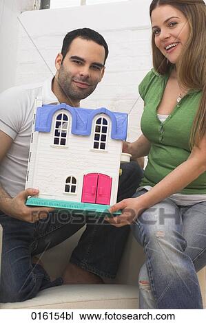 young couple with miniature house View Large Photo Image Stock Image - young couple with miniature house. Fotosearch