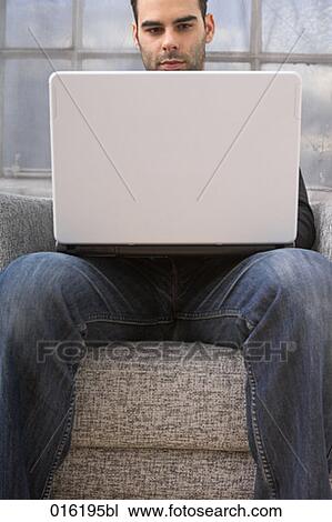 young man working with laptop computer at home View Large Photo Image Stock Image - young man working with laptop computer at home. Fotosearch