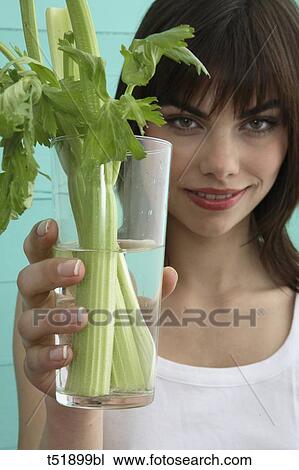 Stock Image - Young woman and celery . Fotosearch