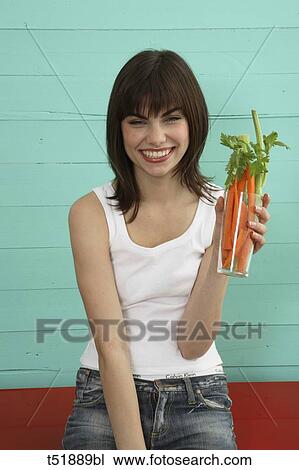 Young woman eats vegetables View Large Photo Image Stock Image - Young woman eats vegetables . Fotosearch