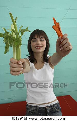 Young woman eats vegetables View Large Photo Image Stock Image - Young woman eats vegetables . Fotosearch
