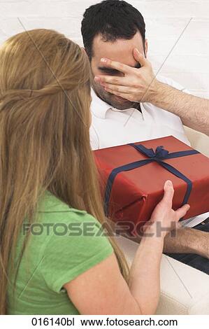 young woman giving present to man View Large Photo Image Stock Image - young woman giving present to man. Fotosearch