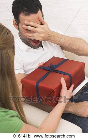 young woman giving present to man View Large Photo Image Stock Image - young woman giving present to man. Fotosearch