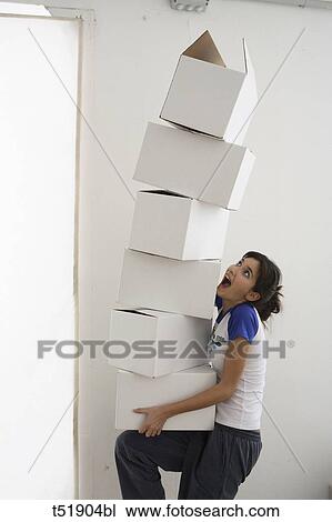 Young woman takes a stack of paper boxes View Large Photo Image Stock Image - Young woman takes a stack of paper boxes . Fotosearch