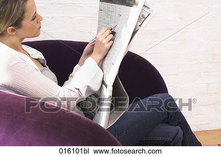 young woman with newspaper marking classified ads with pen View Large Photo Image Stock Image - young woman with newspaper marking classified ads with pen. Fotosearch