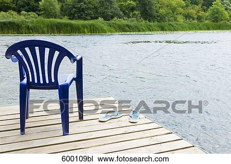 blue chair and pair of flip flops on pier near lake View Large Photo Image Stock Image - blue chair and pair of flip flops on pier near lake. Fotosearch