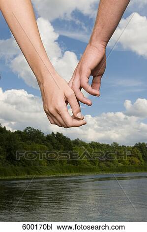 close-up of young couple holding hands View Large Photo Image Stock Image - close-up of young couple holding hands. Fotosearch