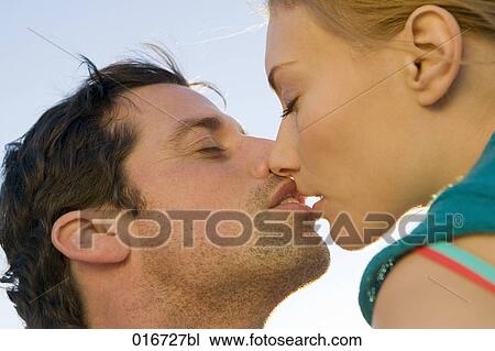 Stock Image - close-up of young couple kissing. Fotosearch