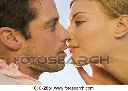 Stock Image - close-up of young couple kissing. Fotosearch
