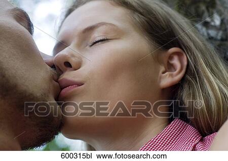 Stock Image - close-up of young couple kissing. Fotosearch