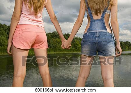 detail of two young women holding hands View Large Photo Image Stock Image - detail of two young women holding hands. Fotosearch