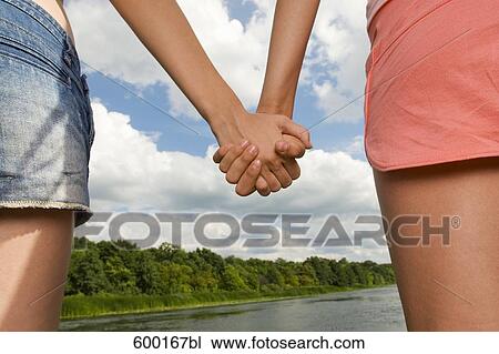 detail of two young women holding hands View Large Photo Image Stock Image - detail of two young women holding hands. Fotosearch