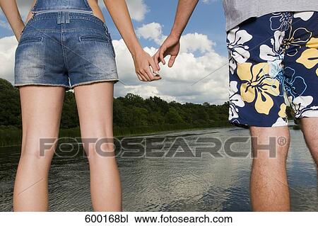 detail of young woman and young man holding hands View Large Photo Image Stock Image - detail of young woman and young man holding hands. Fotosearch