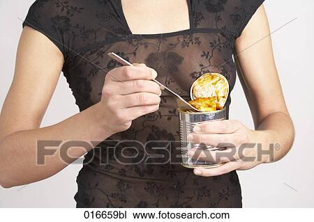 detail of young woman eating ravioli out of the can View Large Photo Image Stock Image - detail of young woman eating ravioli out of the can. Fotosearch