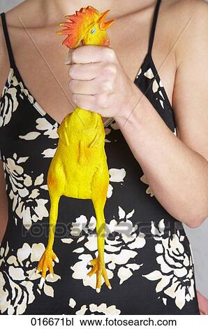 Stock Image - detail of young woman holding rubber cock. Fotosearch