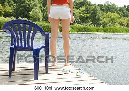 detail of young woman standing on pier near lake View Large Photo Image Stock Image - detail of young woman standing on pier near lake. Fotosearch