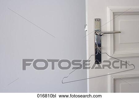 empty hanger hanging on door knob View Large Photo Image Stock Image - empty hanger hanging on door knob. Fotosearch