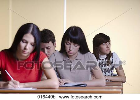 Stock Image - female student day-dreaming during school seminar. Fotosearch