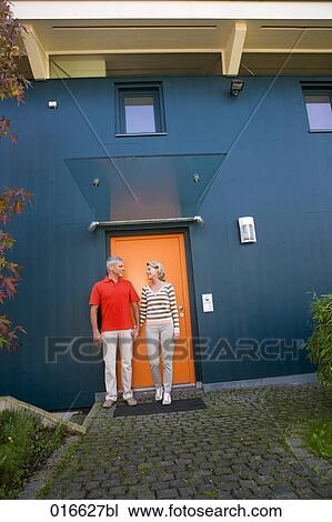 full body portrait of mature couple standing at front door of their home View Large Photo Image Stock Image - full body portrait of mature couple standing at front door of their home. Fotosearch