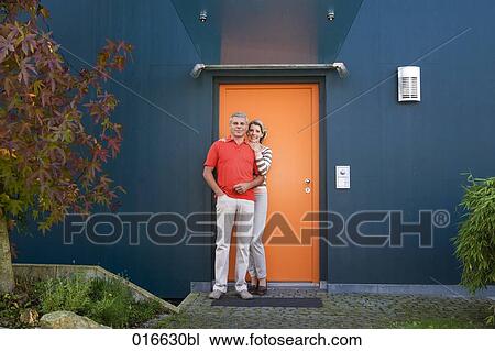 full body portrait of mature couple standing at front door of their home View Large Photo Image Stock Image - full body portrait of mature couple standing at front door of their home. Fotosearch