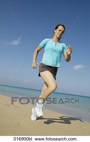 full body portrait of young woman jogging on beach View Large Photo Image Stock Image - full body portrait of young woman jogging on beach. Fotosearch