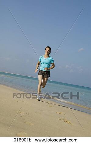full body portrait of young woman jogging on beach View Large Photo Image Stock Image - full body portrait of young woman jogging on beach. Fotosearch