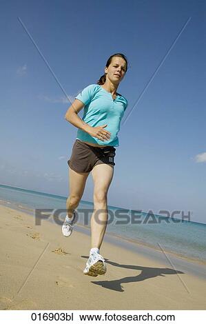 full body portrait of young woman jogging on beach View Large Photo Image Stock Image - full body portrait of young woman jogging on beach. Fotosearch