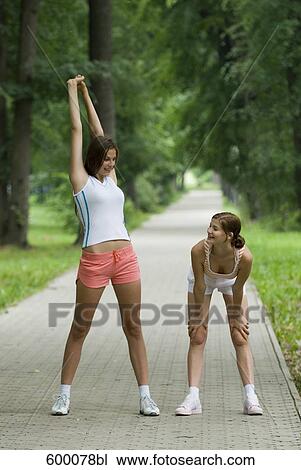 full body portrait of young women doing stretching exercises in park View Large Photo Image Stock Image - full body portrait of young women doing stretching exercises in park. Fotosearch