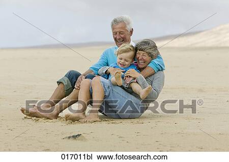 grandparents and toddler having fun on beach View Large Photo Image Stock Image - grandparents and toddler having fun on beach. Fotosearch