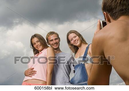group of three friends posing for a portrait View Large Photo Image Stock Image - group of three friends posing for a portrait. Fotosearch