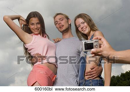 Stock Image - group of three friends posing for a portrait. Fotosearch