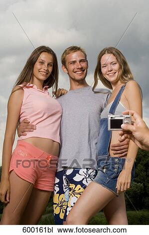 group of three friends posing for a portrait View Large Photo Image Stock Image - group of three friends posing for a portrait. Fotosearch