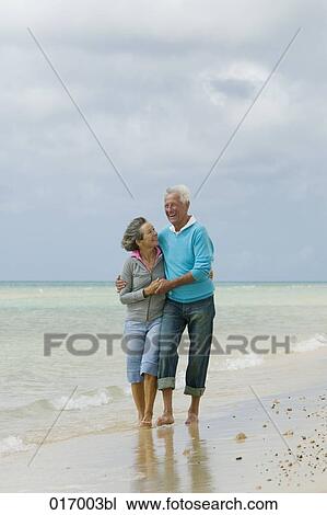 happy mature couple embracing on beach View Large Photo Image Stock Image - happy mature couple embracing on beach. Fotosearch