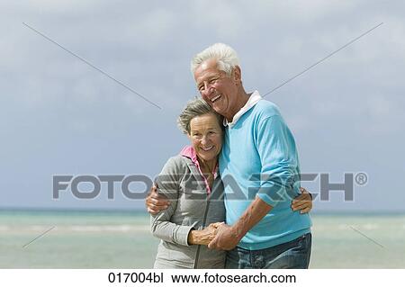 happy mature couple embracing on beach View Large Photo Image Stock Image - happy mature couple embracing on beach. Fotosearch
