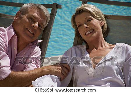 headshot of mature couple on sun loungers View Large Photo Image Stock Image - headshot of mature couple on sun loungers. Fotosearch