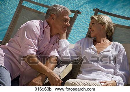 headshot of mature couple on sun loungers View Large Photo Image Stock Image - headshot of mature couple on sun loungers. Fotosearch