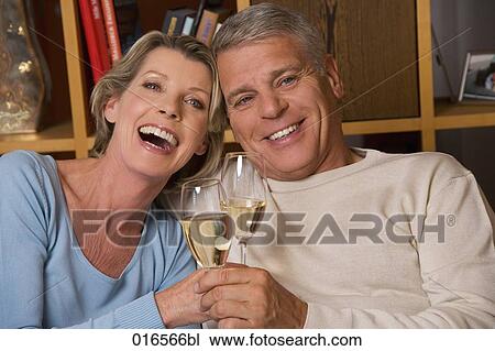Stock Image - headshot of mature couple with champagne glasses. Fotosearch