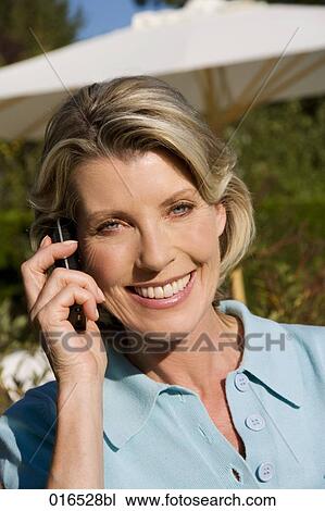 headshot of mature woman talking on mobile phone View Large Photo Image Stock Image - headshot of mature woman talking on mobile phone. Fotosearch