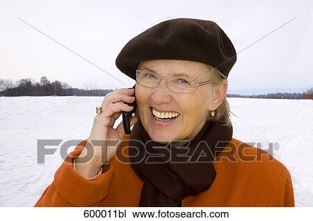 headshot of mature woman wearing brown beret talking on mobile phone View Large Photo Image Stock Image - headshot of mature woman wearing brown beret talking on mobile phone. Fotosearch