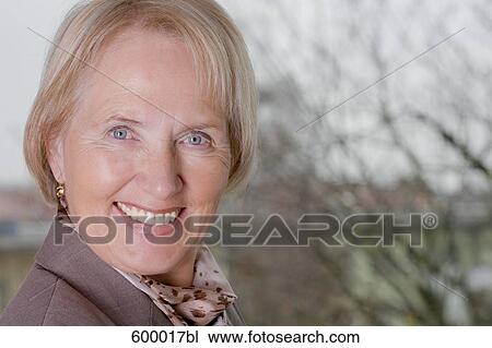 Stock Image - headshot of smiling mature woman. Fotosearch