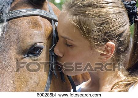 headshot of teenage girl kissing brown horse View Large Photo Image Stock Image - headshot of teenage girl kissing brown horse. Fotosearch