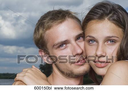 headshot of young couple cheek to cheek View Large Photo Image Stock Image - headshot of young couple cheek to cheek. Fotosearch