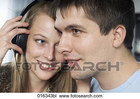 headshot of young couple listening to music together View Large Photo Image Stock Image - headshot of young couple listening to music together. Fotosearch